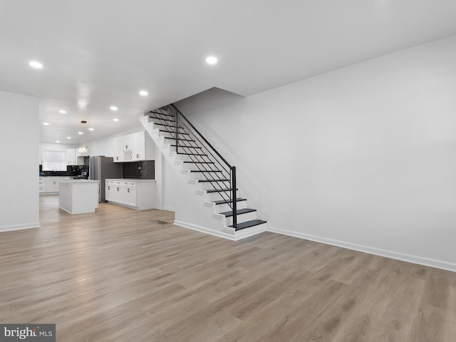 unfurnished living room featuring light wood-type flooring