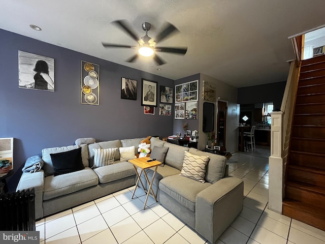 tiled living room with ceiling fan