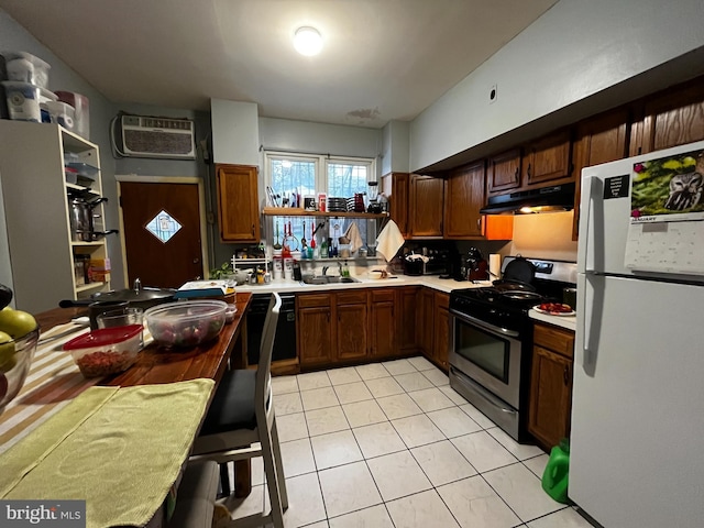 kitchen with sink, black dishwasher, stainless steel gas range oven, a wall mounted AC, and white fridge