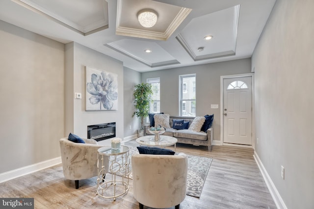 living room featuring light wood-type flooring, crown molding, and coffered ceiling