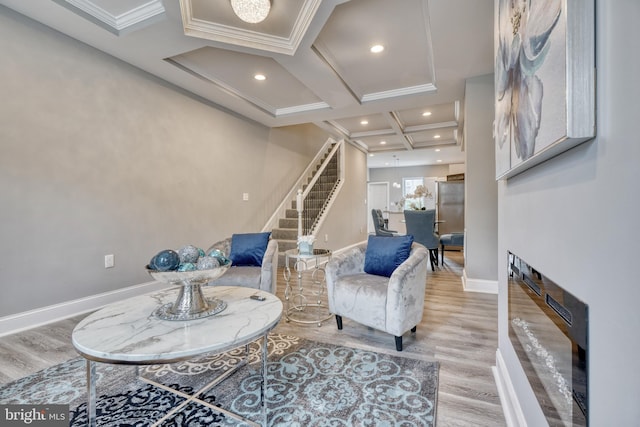 living area featuring hardwood / wood-style floors, ornamental molding, coffered ceiling, and beam ceiling