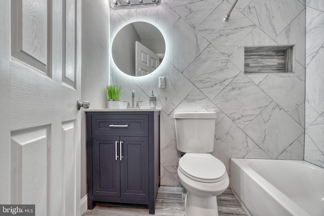 bathroom with wood-type flooring, vanity, toilet, and tile walls