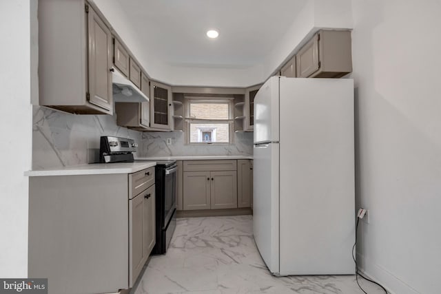 kitchen with black electric range, backsplash, white fridge, and gray cabinets