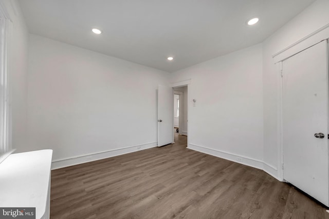 unfurnished room with hardwood / wood-style flooring