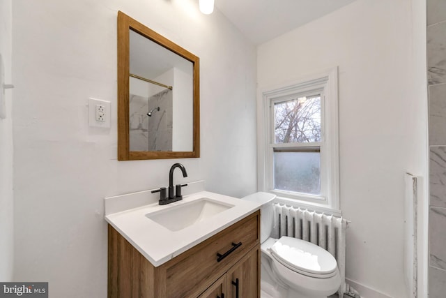 bathroom featuring radiator heating unit, vanity, toilet, and walk in shower