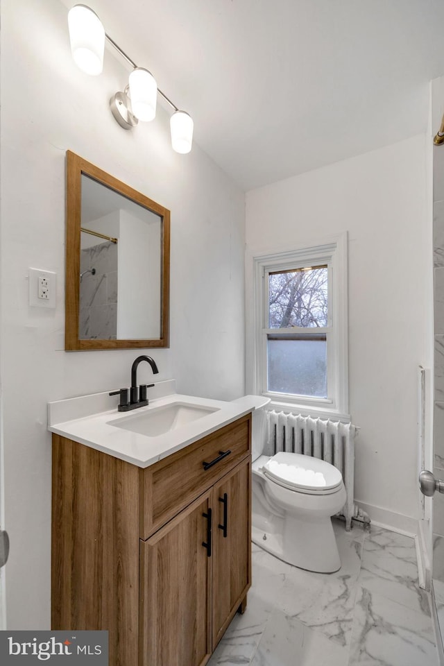 bathroom featuring radiator heating unit, vanity, and toilet