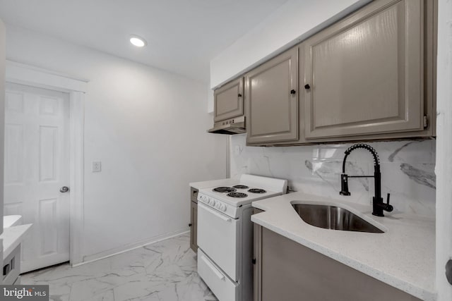 kitchen featuring light stone counters, tasteful backsplash, white range with electric stovetop, and sink