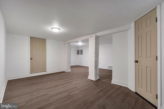 basement with dark hardwood / wood-style flooring and baseboard heating