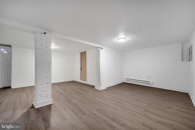 basement with hardwood / wood-style floors and a baseboard heating unit