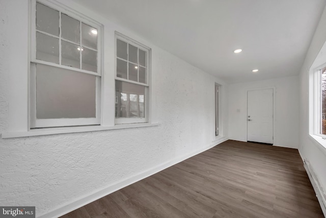 unfurnished room with dark hardwood / wood-style floors