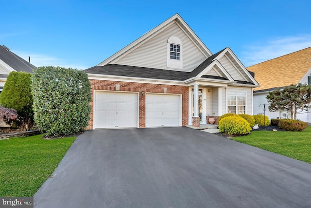 view of front of property with a front yard and a garage