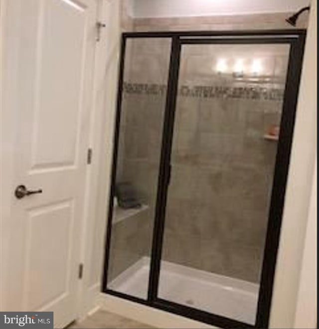 bathroom with a shower with shower door