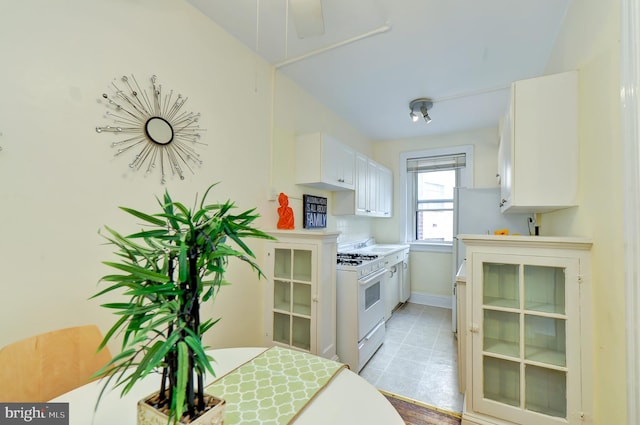 kitchen with white cabinetry and white gas range oven