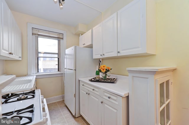 kitchen with white cabinets and white appliances