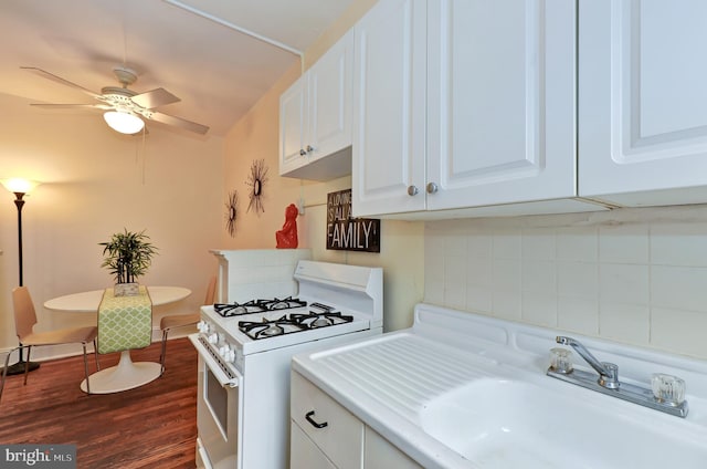 kitchen featuring sink, ceiling fan, white gas range, dark hardwood / wood-style flooring, and white cabinetry