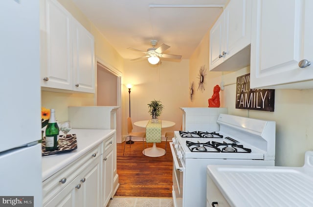 kitchen with white cabinets, ceiling fan, light hardwood / wood-style floors, and white appliances