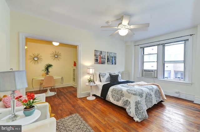 bedroom with radiator, ceiling fan, cooling unit, and dark hardwood / wood-style floors