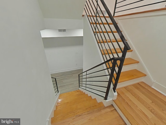 stairway featuring hardwood / wood-style flooring