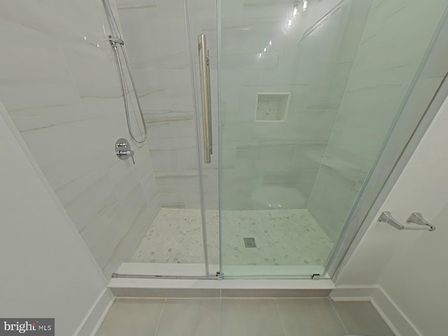 bathroom featuring a shower with shower door