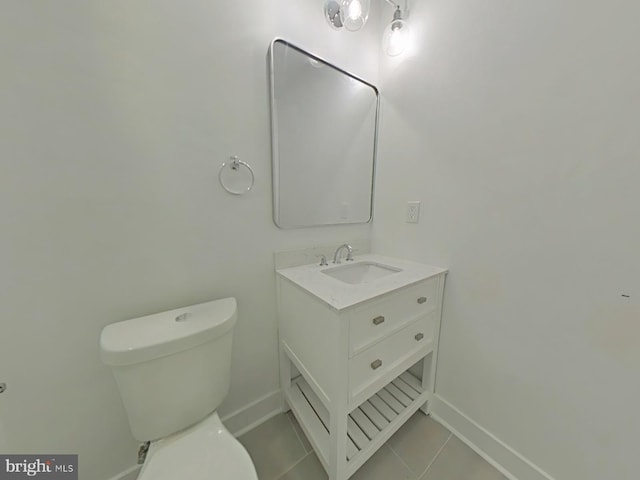 bathroom with tile patterned flooring, vanity, and toilet