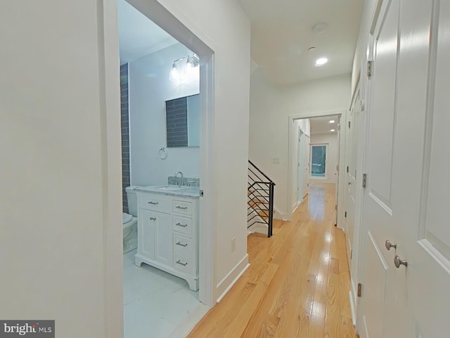 hall with sink and light hardwood / wood-style floors