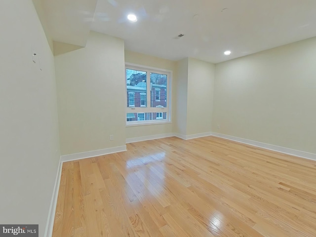 spare room featuring light hardwood / wood-style flooring