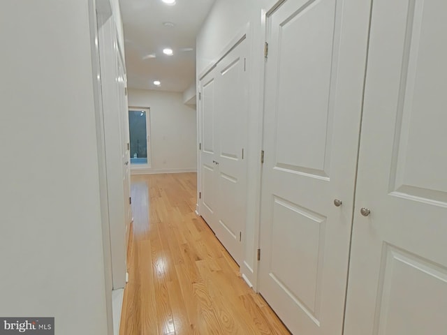 hallway with light wood-type flooring