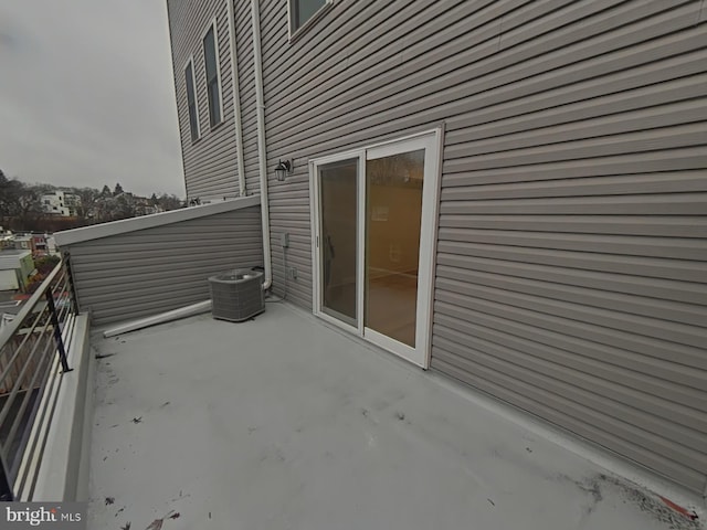 view of patio with central AC unit and a balcony