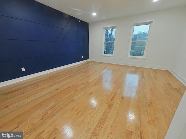 empty room with light hardwood / wood-style floors