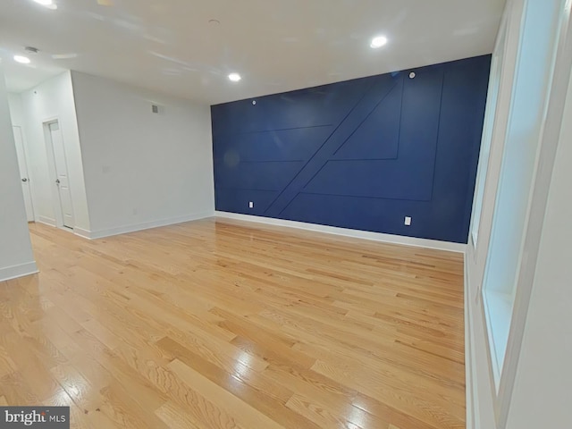 spare room with light hardwood / wood-style flooring