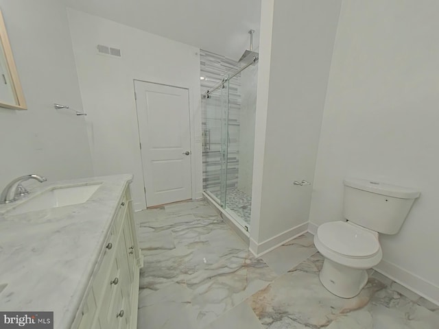 bathroom featuring vanity, toilet, and a shower with shower door