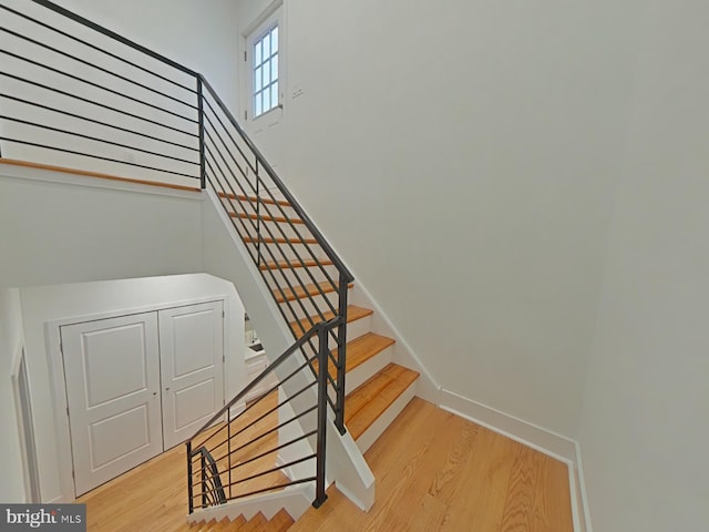 stairs featuring hardwood / wood-style flooring