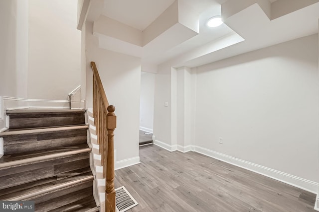 stairs with hardwood / wood-style floors