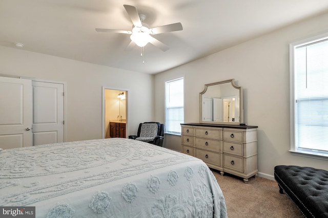 carpeted bedroom with connected bathroom and ceiling fan