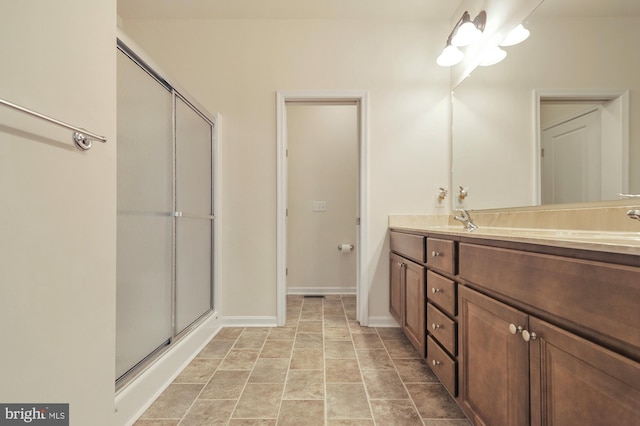 bathroom with tile patterned floors, vanity, and walk in shower