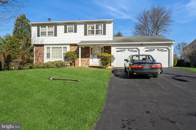 front facade with a front yard and a garage