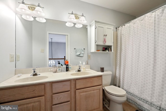 bathroom with a shower with shower curtain, vanity, and toilet