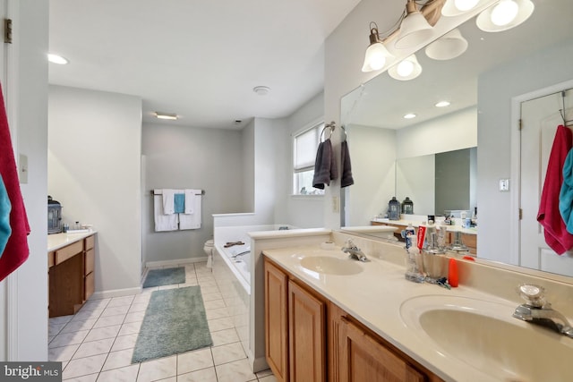 bathroom with tile patterned flooring, vanity, and a tub to relax in