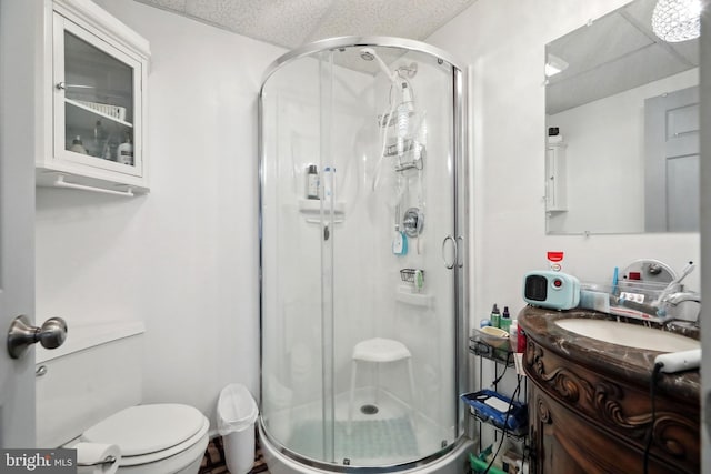 bathroom featuring vanity, toilet, and walk in shower