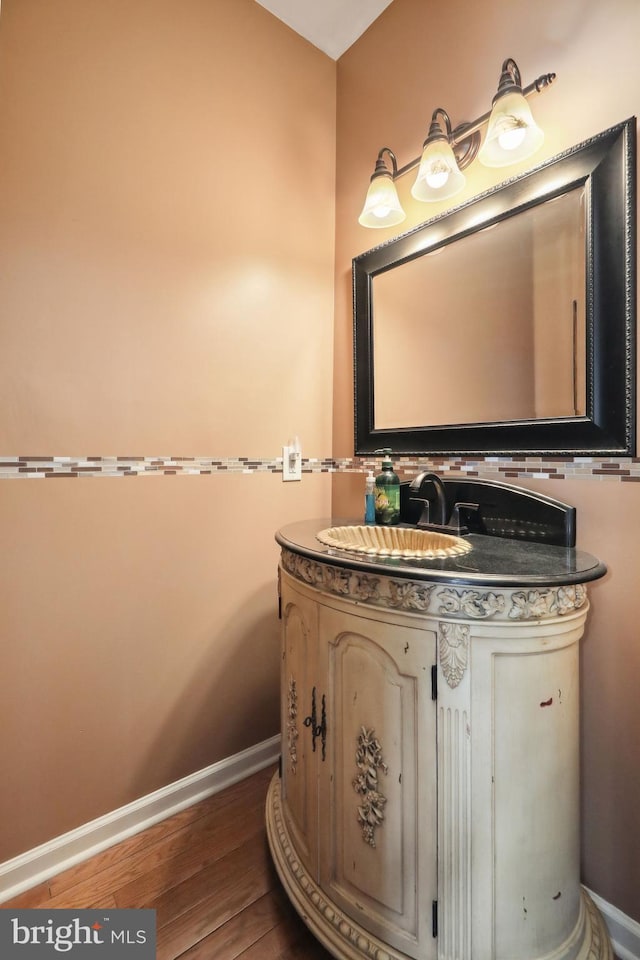 bathroom with hardwood / wood-style flooring and vanity