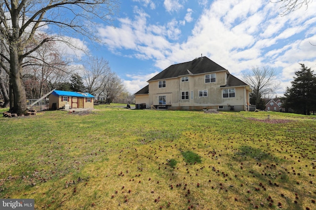 view of yard featuring central AC unit and an outbuilding