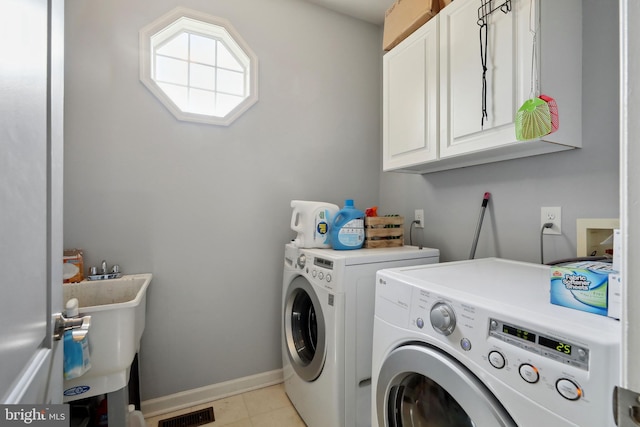 laundry room featuring cabinets, independent washer and dryer, sink, and light tile patterned floors