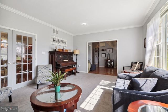 carpeted living room with french doors and ornamental molding