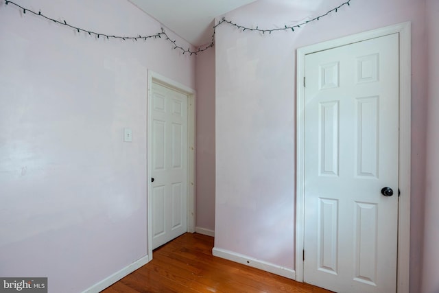 unfurnished room with wood-type flooring