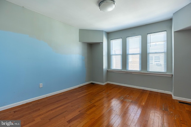 unfurnished room featuring wood-type flooring