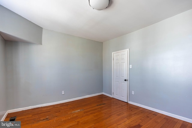 spare room with hardwood / wood-style floors