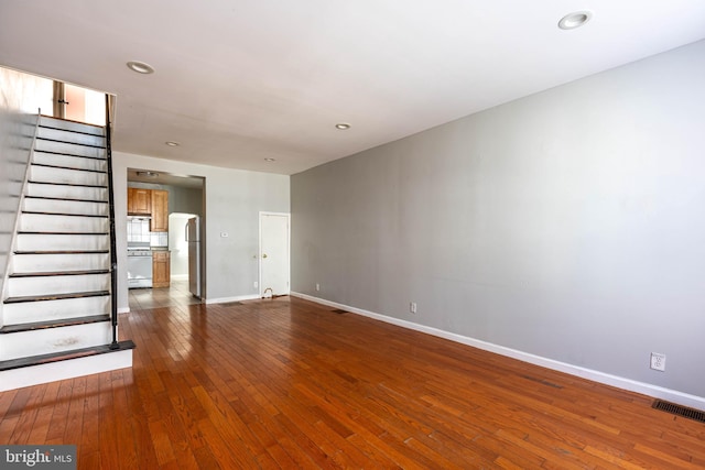 unfurnished living room with hardwood / wood-style flooring