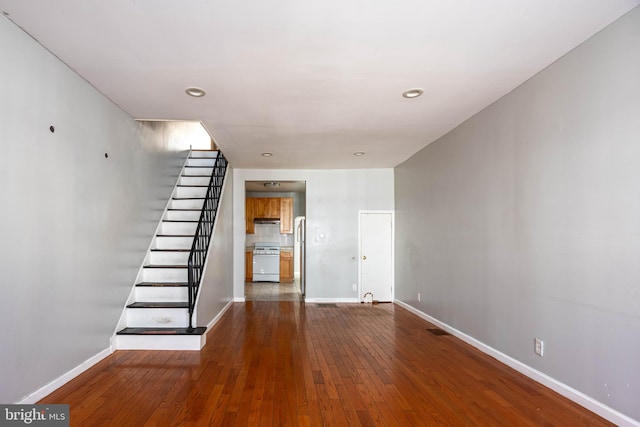 unfurnished living room with hardwood / wood-style flooring