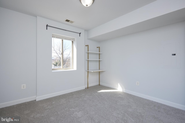 spare room featuring carpet floors, baseboards, and visible vents