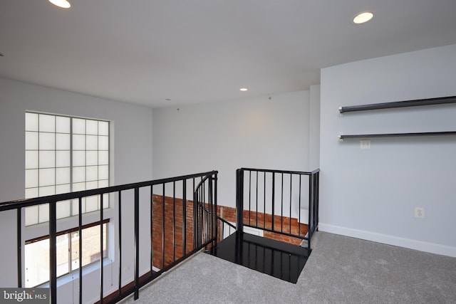 hallway with baseboards, carpet, an upstairs landing, and recessed lighting